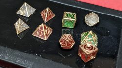 Perspective photograph 1 of 1:12 scale red, green and white Holocrons that have had their edges painted gold.