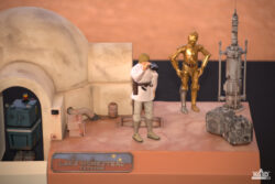 Shot of the right side of the completed Lars Homestead diorama featuring Luke Skywalker and C-3PO