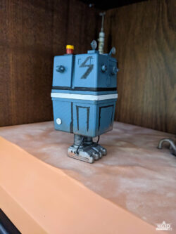 Photo showing right side of painted GNK power droid, with straight legs.