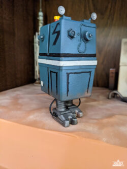 Photo showing front and right sides of painted GNK power droid, with right foot forward