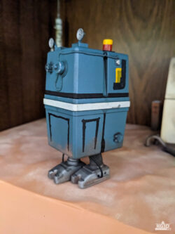 Photo showing left side of painted GNK power droid, with right foot forward
