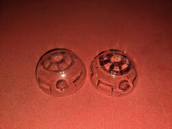 2 paneled domes next to each other. The left one is foggy and the right one isn't. The difference was simply adding a tiny bit of vegetable oil to the buck before vacuum forming the dome.