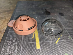 The paint mask for painting the inside of the dome, with an unpainted dome next to it.