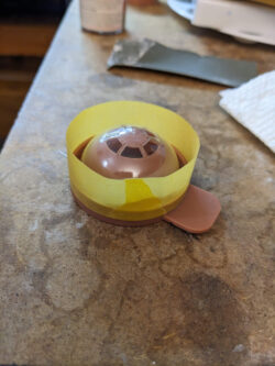 The paint mask with the dome snapped in place and masking tape around the outside to prevent overspray.